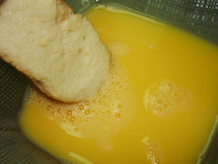 Torrijas dipped in egg wash