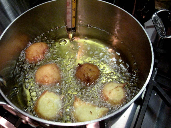Orange donut holes cooking