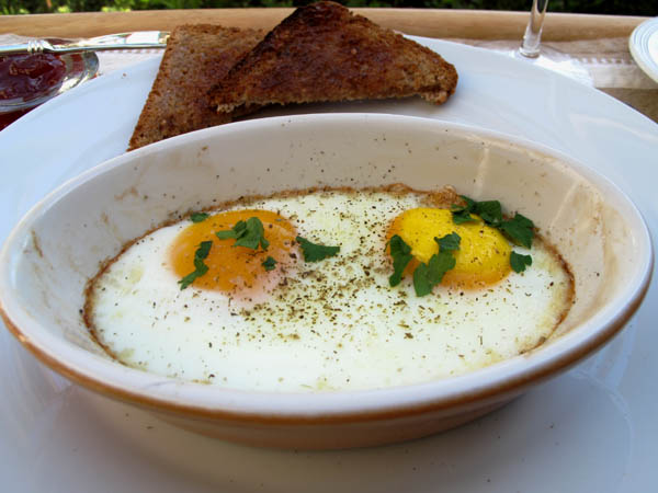 Baked eggs in dish closeup
